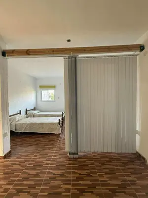 a bedroom with a bed and a large sliding door at Depto Santa Cruz in Villa Santa Cruz del Lago