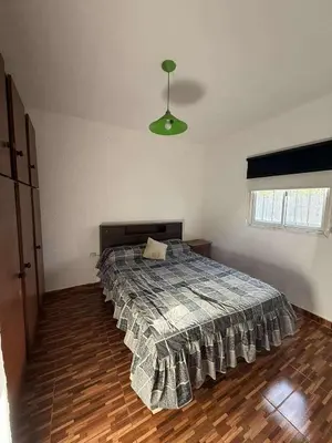 a bedroom with a bed in the middle of it at Depto Santa Cruz in Villa Santa Cruz del Lago