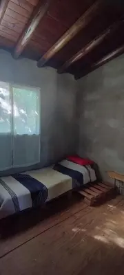 two beds sitting in a room with a window at NATURAL Tanti Lomas in Tanti