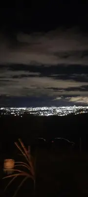 a view of a city at night with lights at NATURAL Tanti Lomas in Tanti