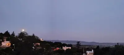 a moon sitting on top of a hill with houses at NATURAL Tanti Lomas in Tanti
