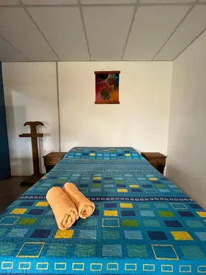 a bed in a room with two towels on it at Cabañas La Chakana in Cortaderas