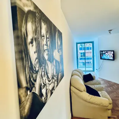 a living room with a large picture on the wall at Ayres de Córdoba 4, Asador, Terraza, Balcón, Excelente Ubicación in Cordoba
