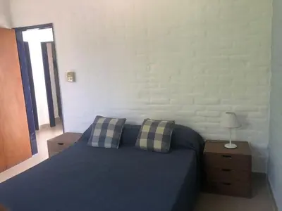 a bedroom with a blue bed with two pillows at casa 8 personas in Mina Clavero