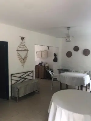 a living room with two tables and a room with two tables at casa 8 personas in Mina Clavero