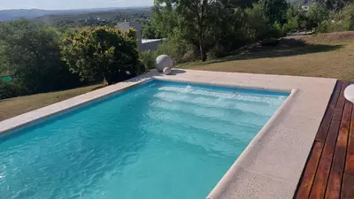 a swimming pool in the backyard of a house at CASA DE CATEGORIA EN LAS SIERRAS de CORDOBA in San Antonio de Arredondo