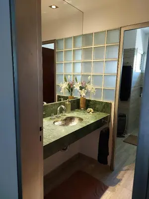 a bathroom with a sink and a mirror at CASA DE CATEGORIA EN LAS SIERRAS de CORDOBA in San Antonio de Arredondo