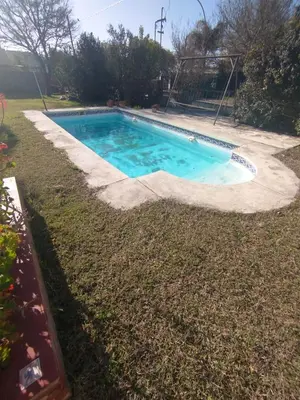 a swimming pool in the middle of a yard at Casa Costa Lago in Villa Carlos Paz