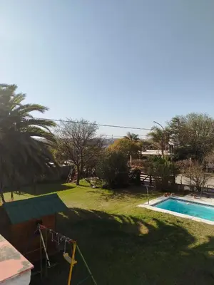 a yard with a swimming pool and a playground at Casa Costa Lago in Villa Carlos Paz