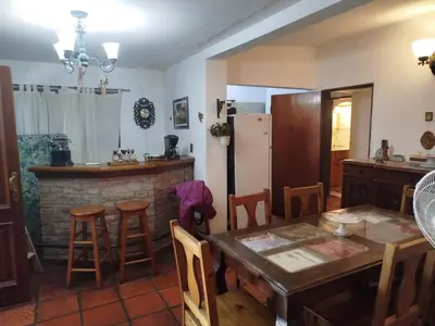 a kitchen and a dining room with a table and chairs at Casa Costa Lago in Villa Carlos Paz