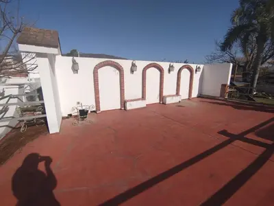 a shadow of a person taking a picture of a building at Casa Costa Lago in Villa Carlos Paz