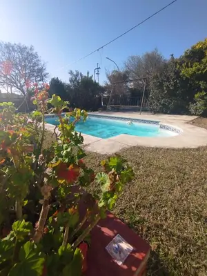 a swimming pool in the middle of a yard at Casa Costa Lago in Villa Carlos Paz