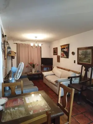 a living room with a couch and a table at Casa Costa Lago in Villa Carlos Paz