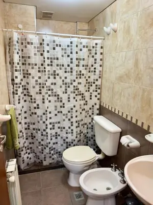 a bathroom with a toilet and a shower curtain at Guten Morgen VCP in Villa Carlos Paz