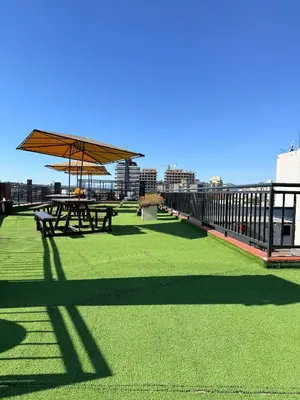 a patio with picnic tables on the roof of a building at Guten Morgen VCP in Villa Carlos Paz
