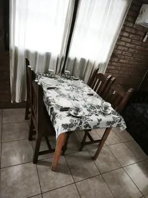 a dining room table with a floral table cloth on it at Departamento Villa Cabrera in Cordoba