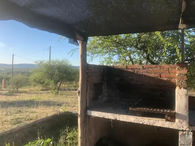 a brick wall with a beehive in a field at Casita El Mirador Trasla in Arroyo de Los Patos