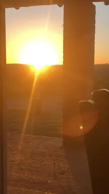 a sunset seen through a window with the sun setting at Casita El Mirador Trasla in Arroyo de Los Patos