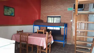 a room with a table and a bunk bed at Don Pinelli dptos in Alpa Corral