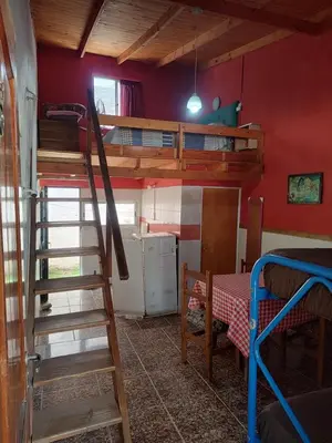 a room with a bunk bed and a ladder at Don Pinelli dptos in Alpa Corral
