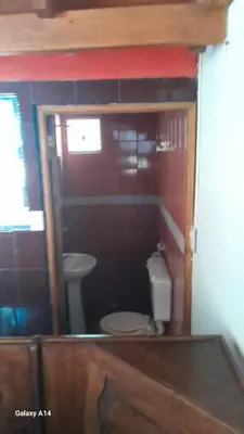 a small bathroom with a toilet and a sink at Don Pinelli dptos in Alpa Corral