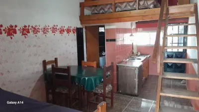 a kitchen with a table and a bunk bed at Don Pinelli dptos in Alpa Corral