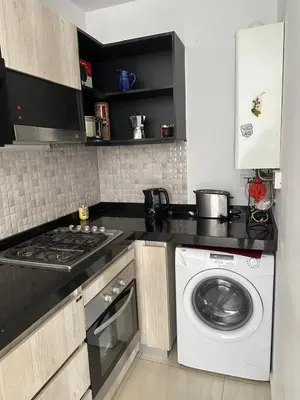 a kitchen with a stove and a washing machine at Casa de Mary in Villa Carlos Paz
