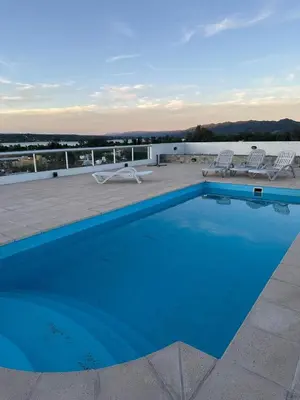 a blue swimming pool on top of a roof at Casa de Mary in Villa Carlos Paz