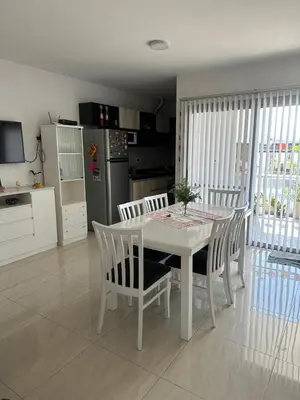 a kitchen and dining room with a white table and chairs at Casa de Mary in Villa Carlos Paz