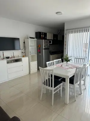 a kitchen and dining room with a white table and chairs at Casa de Mary in Villa Carlos Paz
