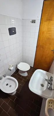 a bathroom with a toilet and a sink at Hotel Francesco in Mina Clavero