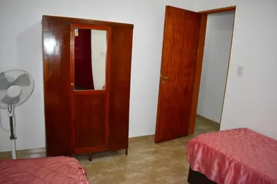 a bedroom with two doors and a fan and a bed at Sierras Del Molle in Santa Rosa de Calamuchita