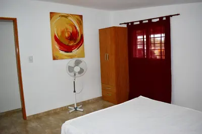 a bedroom with a bed and a painting on the wall at Sierras Del Molle in Santa Rosa de Calamuchita