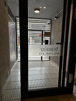 a door to a building with a sign on it at NUEVO a 3 cuadras del shopping Patio Olmos con ASADOR y terraza amoblada in Cordoba