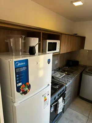 a kitchen with a white refrigerator and a microwave at NUEVO a 3 cuadras del shopping Patio Olmos con ASADOR y terraza amoblada in Cordoba