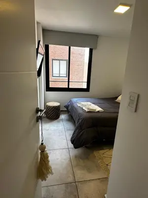 a bedroom with a bed and a window at NUEVO a 3 cuadras del shopping Patio Olmos con ASADOR y terraza amoblada in Cordoba