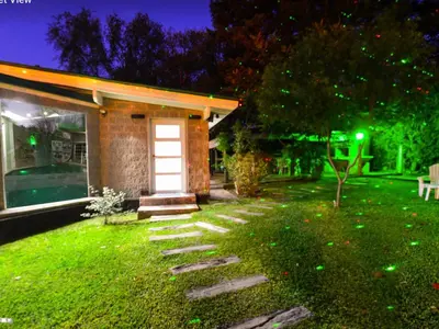 a house with a lawn with a white door at Bad-wiessee Apart Hotel & Spa in Villa General Belgrano