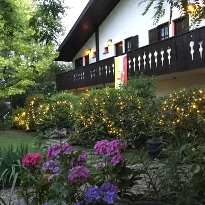 a garden with lights in front of a building at Bad-wiessee Apart Hotel & Spa in Villa General Belgrano