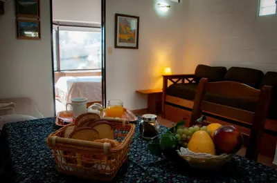 a room with a table with baskets of fruit on it at Bad-wiessee Apart Hotel & Spa in Villa General Belgrano