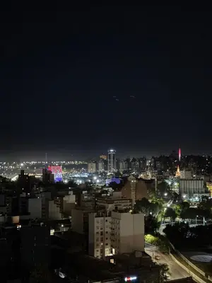 a view of a city at night with lights at Alto Paz Tower Departamentos Premium in Cordoba
