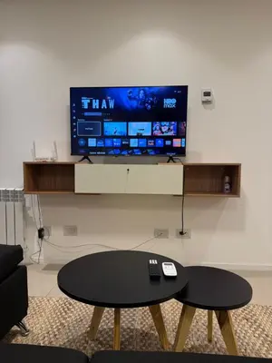 a living room with a table and a flat screen tv at Alto Paz Tower Departamentos Premium in Cordoba