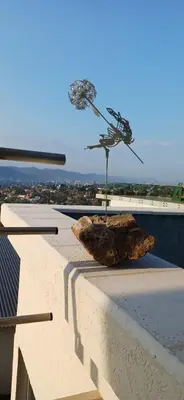 a sculpture on top of a building with a rock at Anima Lodge 2 in Villa Carlos Paz