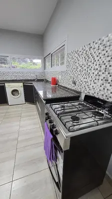 a kitchen with a stove and a counter top at Las Nalichas in Villa Carlos Paz