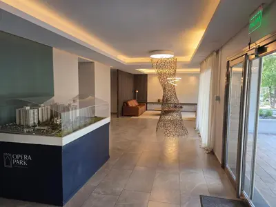 a lobby of a hotel with a large light fixture at Apartamento Ópera Park in Cordoba
