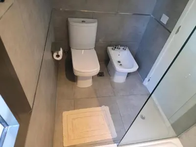 a small bathroom with a toilet and a sink at Apartamento Ópera Park in Cordoba