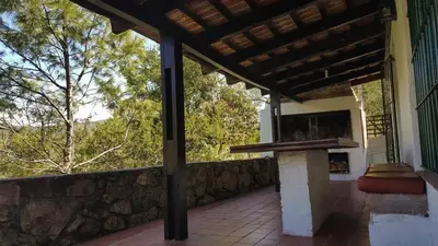 a porch of a house with a stone wall at Mountain house in Costa Blanca in Cuesta Blanca