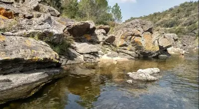 a body of water with some rocks in it at Mountain house in Costa Blanca in Cuesta Blanca