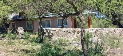 a stone wall in front of a house at El Paraíso de las Chacras in Las Chacras (La Paz)