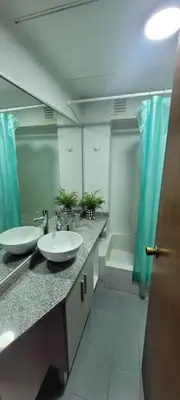 a bathroom with two sinks and a large mirror at Departamento Plaza San Martín in Cordoba