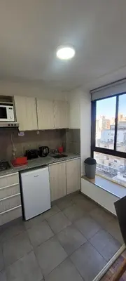a kitchen with a white refrigerator and a window at Departamento Plaza San Martín in Cordoba